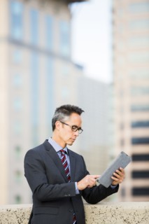 Mixed race businessman using digital tablet