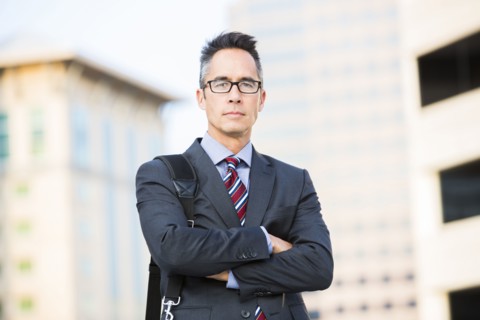 Mixed race businessman standing outdoors