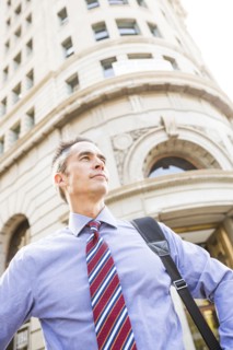 Mixed race businessman standing outdoors