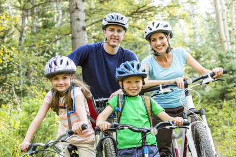 Caucasian family riding mountain bikes