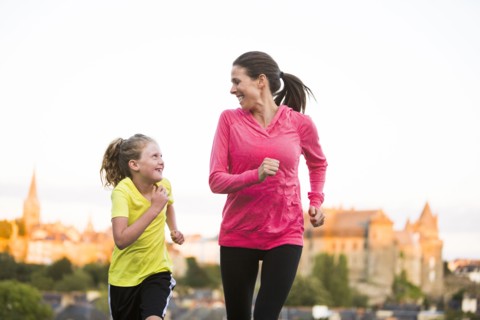 Caucasian mother and daughter jogging outdoors