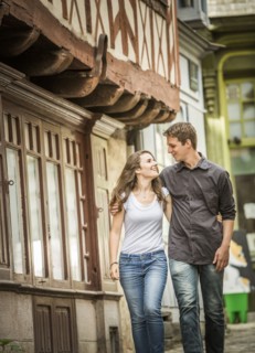 Caucasian couple walking in village