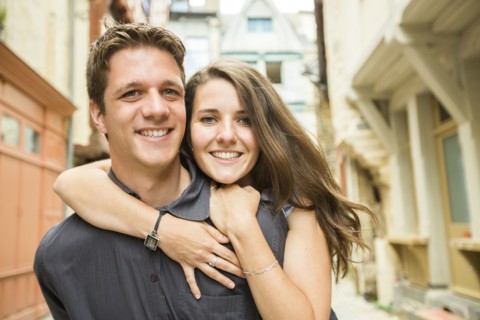 Caucasian couple hugging in village