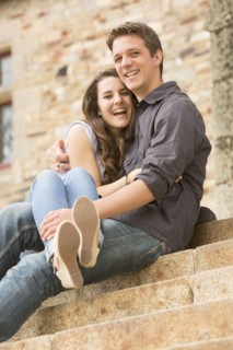 Caucasian couple sitting on castle steps