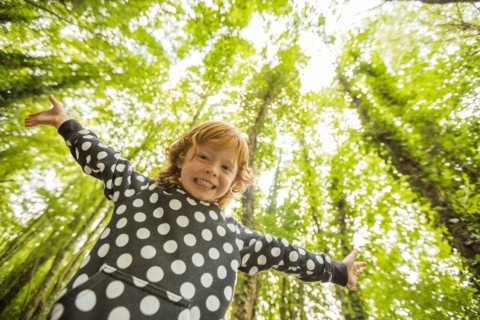 Caucasian girl standing in forest