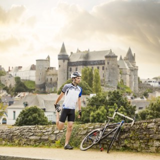 Caucasian cyclist stretching outdoors