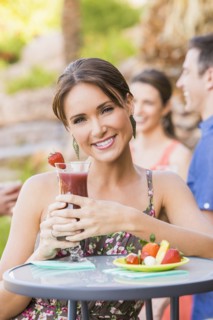 Woman drinking cocktail outdoors