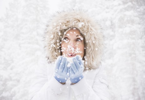 Caucasian woman playing in snow