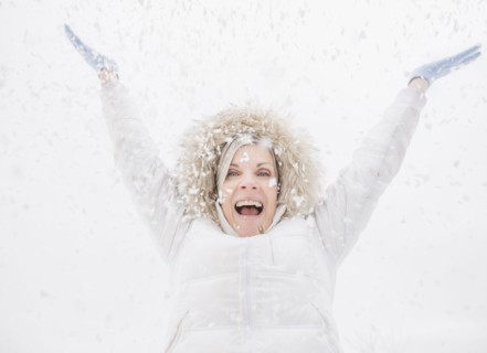 Caucasian woman playing in snow