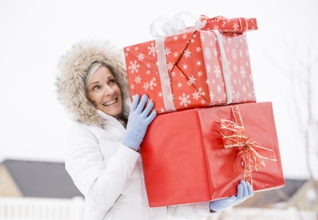 Caucasian woman carrying Christmas gifts