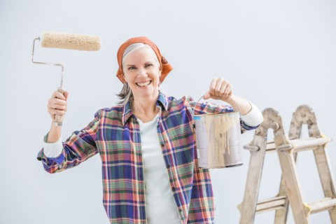 Caucasian woman painting in new home