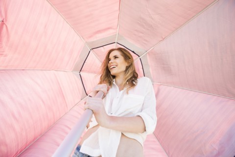 Caucasian woman holding umbrella