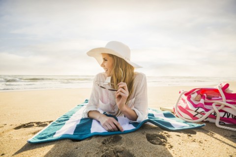 Caucasian woman laying on beach