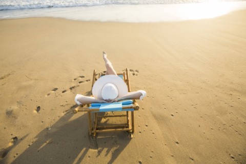 Caucasian woman laying on beach
