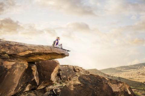 Caucasian woman sitting on rock formation