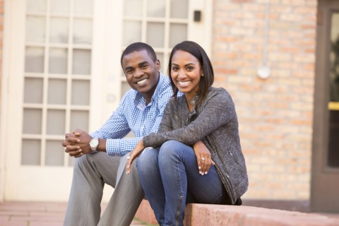 Smiling couple sitting on steps