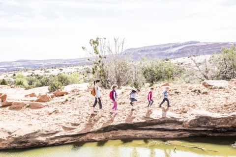 Caucasian mother and children hiking near river