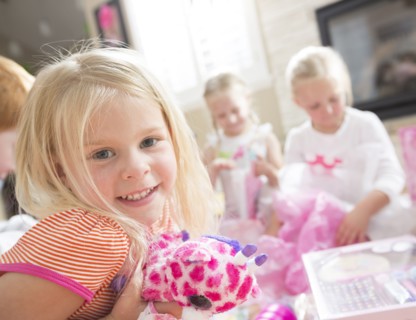 Caucasian girl holding gift at party