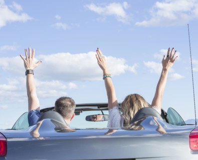Caucasian couple driving in sports car