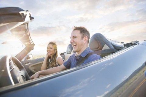 Caucasian couple driving in sports car