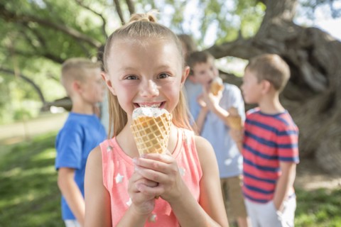 Caucasian girl eating ice cream cone