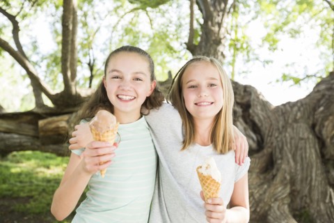 Caucasian girls eating ice cream cones