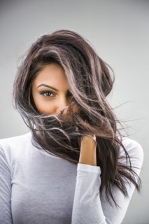 Hair blowing in face of Indian woman