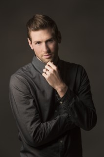 Serious Caucasian man with hand on chin