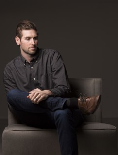 Serious Caucasian man sitting in armchair