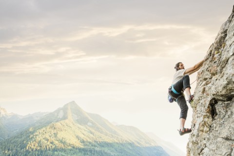 Caucasian man rock climbing