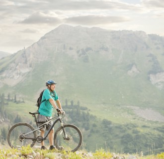 Caucasian man standing with mountain bike