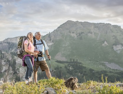 Caucasian couple hiking on mountain
