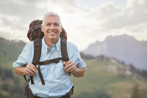 Caucasian man hiking on mountain