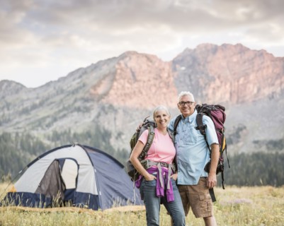 Caucasian couple camping on mountain