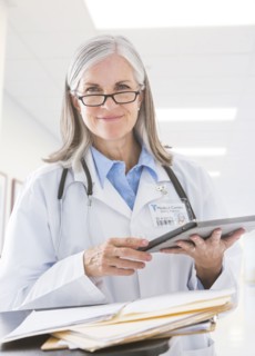 Caucasian doctor holding digital tablet in hospital