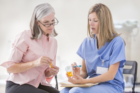 Caucasian nurse explaining prescription to patient