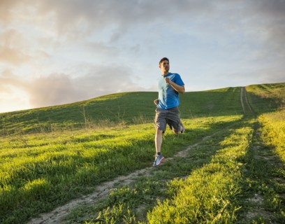 Hispanic man running on hill