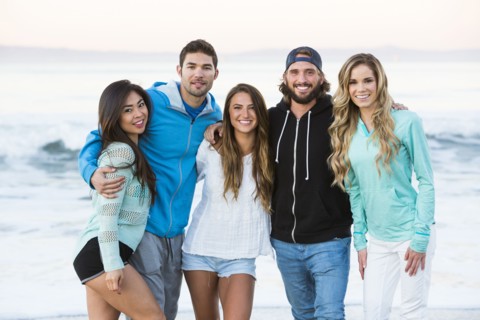 Smiling friends posing at beach
