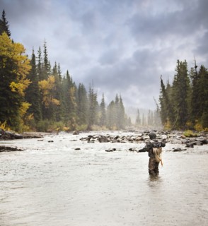 Caucasian man fishing in river