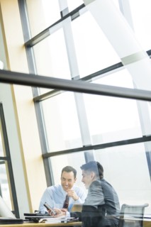 Businessmen smiling in meeting