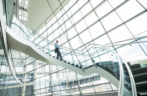 Mixed Race businessman descending staircase