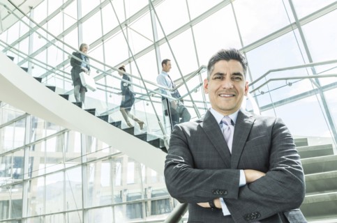Portrait of businessman standing near staircase