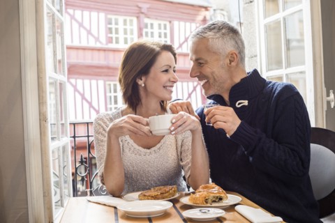 Caucasian couple drinking coffee at breakfast