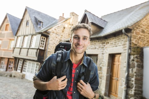 Caucasian man backpacking in city