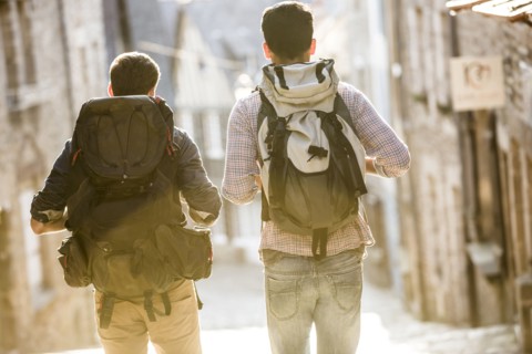 Men backpacking in city