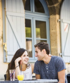 Caucasian couple hugging at restaurant