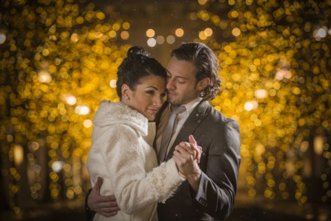 Caucasian couple dancing at night