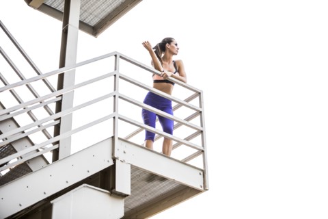 Caucasian woman leaning on urban staircase