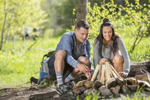 Couple building campfire in the woods