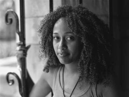 Mixed race woman standing near window